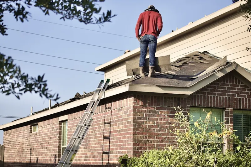 Professional roofer working on a residential roof in Hooverton